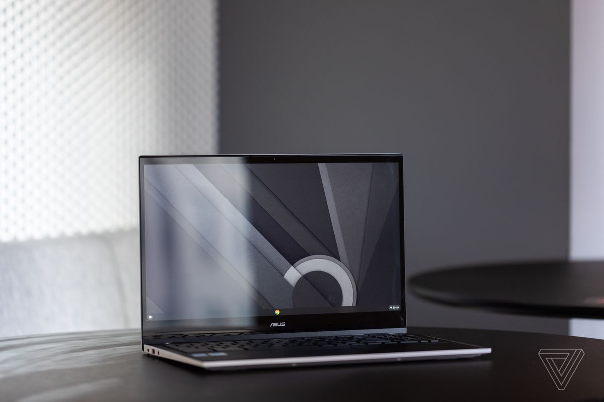 Asus Chromebook CX5 otwarty, ustawiony pod kątem w prawo, na stole z szaro-białym tłem.  Na ekranie wyświetlany jest czarny, biały i szary wzór pulpitu.