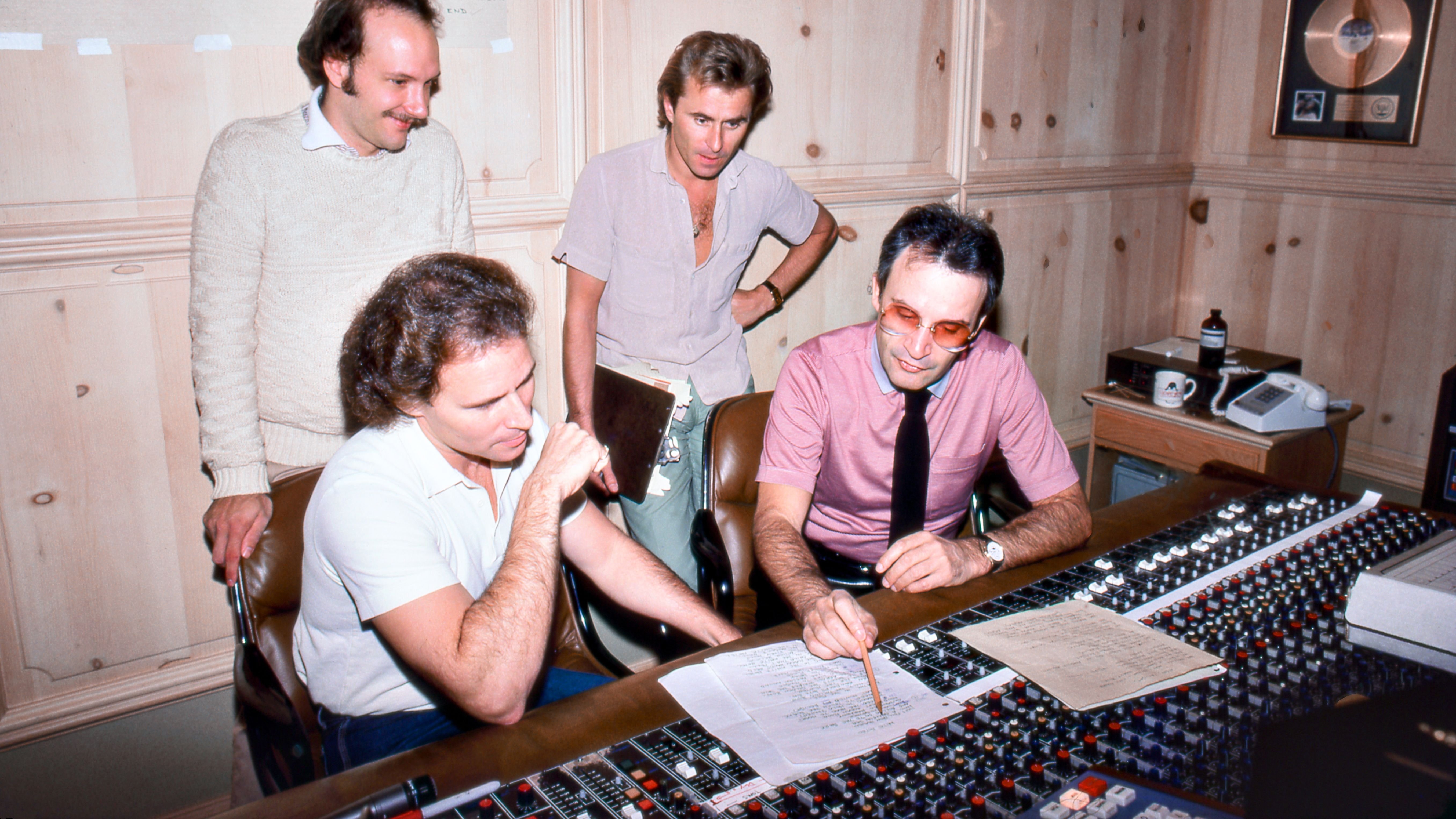 Włoski kompozytor i producent Giorgio Moroder (w koszuli i remisie) ze swoim zespołem produkcyjnym w listopadzie 1982 r. W rodzinnym studio Moroder w Los Angeles w Kalifornii.